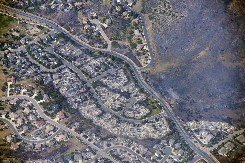 This aerial photo taken on Wednesday, June 27, 2012, shows burned homes in the Mountain Shadows residential area of Colorado Springs, Colo., that were destroyed by the Waldo Canyon wildfire.