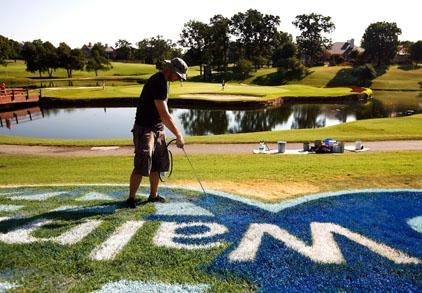 Arkansas Democrat-Gazette/JASON IVESTER --06/28/12--
Jason Jones with Roark Special Projects repaints a Wal-Mart logo on the 15th fairway on Thursday, June 28, 2012, during the pro-am as part of the Wal-Mart NW Arkansas Championship at Pinnacle Country Club in Rogers.