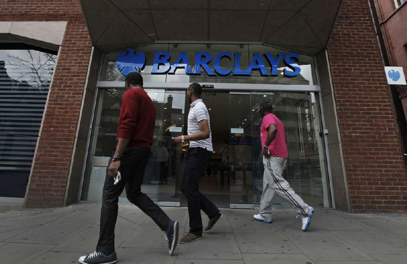 Pedestrians pass a Barclays Bank branch Thursday in London. A British official said Thursday that other global banks are being investigated in the reported financial-market manipulation that led to a $453 million fine for Barclays. 