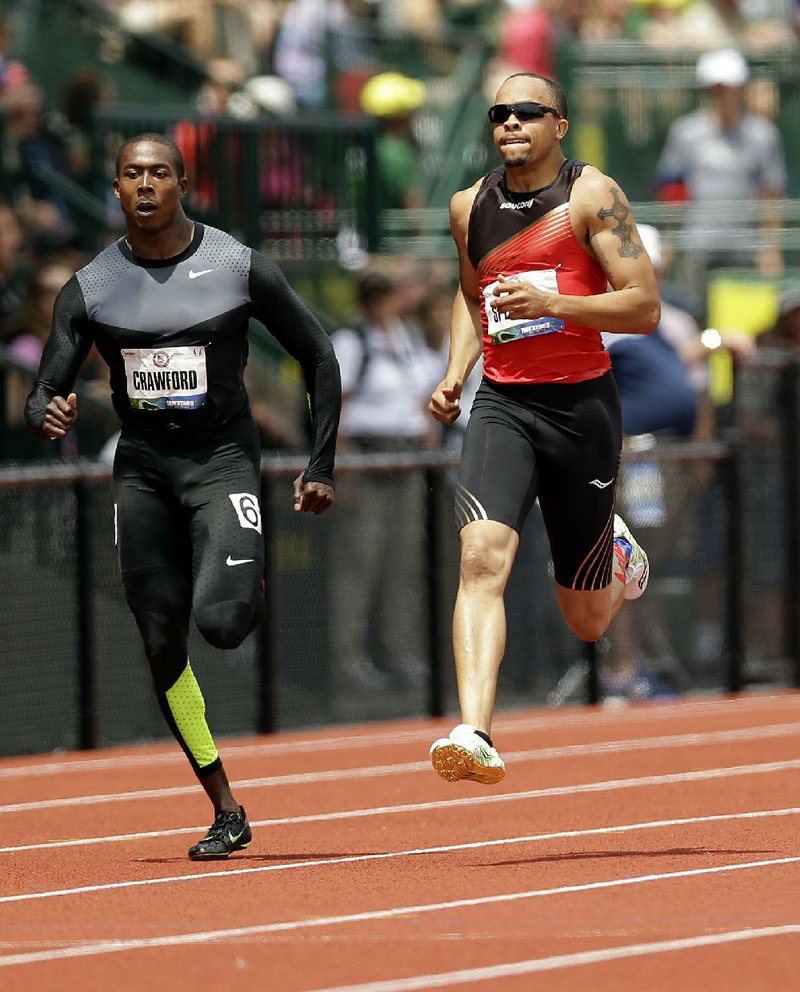 Former Arkansas Razorback Wallace Spearmon (right) finished with Friday’s top qualifying time of 20.17 seconds in the 200 meters at the U.S. Olympic Track and Field Trials in Eugene, Ore. Spearmon and former Razorback LaShawn Butler qualified for today’s 200 semifinals. 