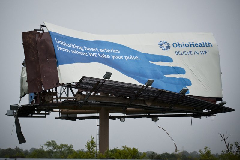 An OhioHealth billboard was mangled from Friday afternoon's severe storm, June 29, 2012. A wave of violent storms sweeping through the mid-Atlantic following a day of record-setting heat in Washington, D.C., has knocked out power to nearly 2 million people. The storms converged Friday night on Washington, D.C., Maryland, Virginia and West Virginia. West Virginia Gov. Earl Ray Tomblin declared a state of emergency after more than 500,000 customers in 27 counties were left without electricity. 
