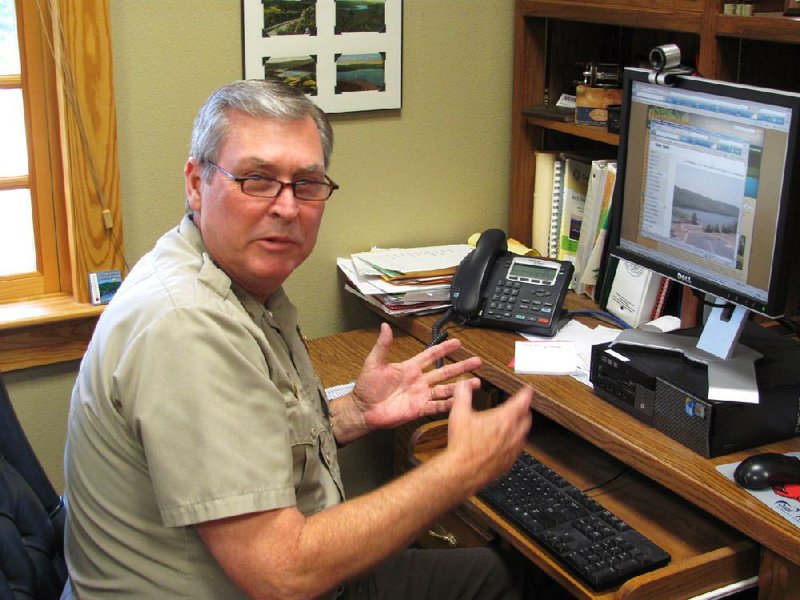 Arkansas Democat-Gazette/DAVE HUGHES

7/6/12

Lake Fort Smith State Park Superintendent Ron Gossage shows Internet surfers can watch live streaming video of various sections of the park. He said amenities at the four-year-old park far exceed those of the old park it replaced.