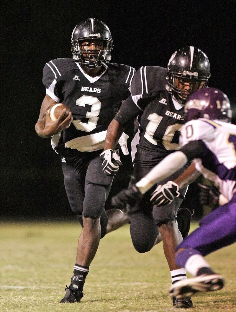 News Times/Michael Orrell

Bearden's Defonta Lowe (3) follows his blocker Marcus Flint as he turns up field against Junction City in the first half at Bearden Friday. JC was leading Bearding 13-12 in the fourth quarter. 