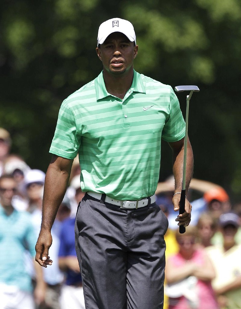 Tiger Woods looks at his putt on the eighth green during the second round of the Greenbrier Classic PGA Golf tournament at the Greenbrier in White Sulphur Springs, W. Va., Friday, July 6, 2012. (AP Photo/Steve Helber)
