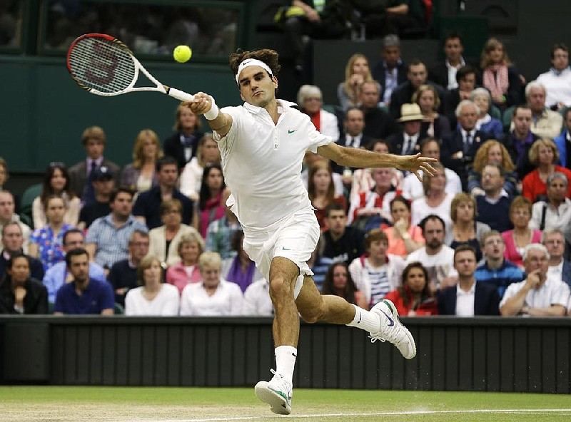 Roger Federer plays a shot to Andy Murray during Sunday’s Wimbledon men’s final match at Wimbledon, England. 