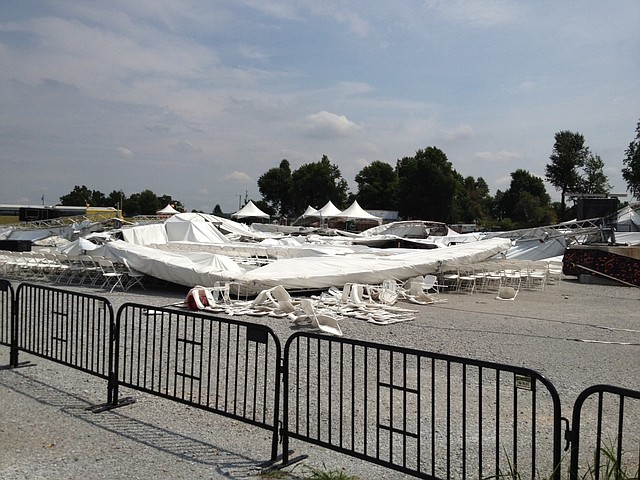 The AMP’s main tent rests on chairs Monday after a storm blew it down Saturday.