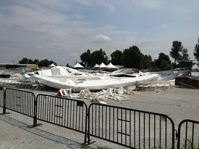The AMP’s main tent rests on chairs Monday after a storm blew it down Saturday.