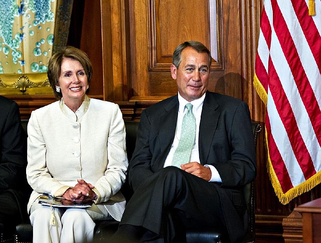 House Minority Leader Nancy Pelosi of Calif., left, and House Speaker John Boehner of Ohio, right, sit together during a ceremony to award the Congressional Gold Medal posthumously to Constantino Brumidi in recognition of his artistic contributions to the US Capitol building, Wednesday, July 11, 2012, on Capitol Hill in Washington.  (AP Photo/J. Scott Applewhite)