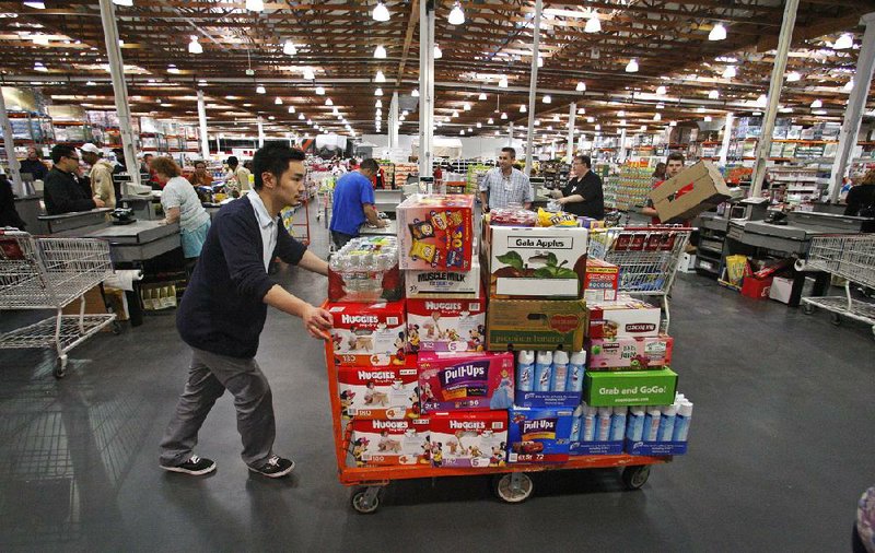 In this Wednesday, May 9, 2012, file photo, David Lee shops at a Costco Wholesale store, in Portland, Ore. (AP Photo/Rick Bowmer, File)