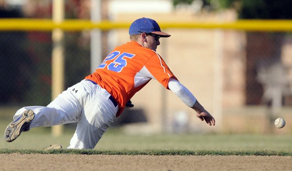 Orin Orlopp, a Rogers second baseman, dives to stop a hit Wednesday during the Optimist’s American Legion game against Poteau, Okla., at Northwest Park in Rogers.