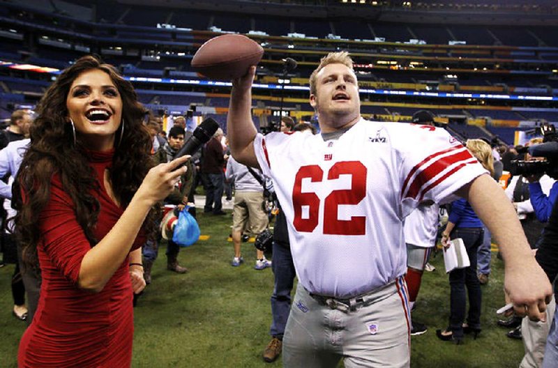FILE — New York Giants offensive guard Mitch Petrus, a former Razorback, throws during Media Day for NFL football's Super Bowl XLVI Tuesday, Jan. 31, 2012, in Indianapolis. (AP Photo/Michael Conroy)