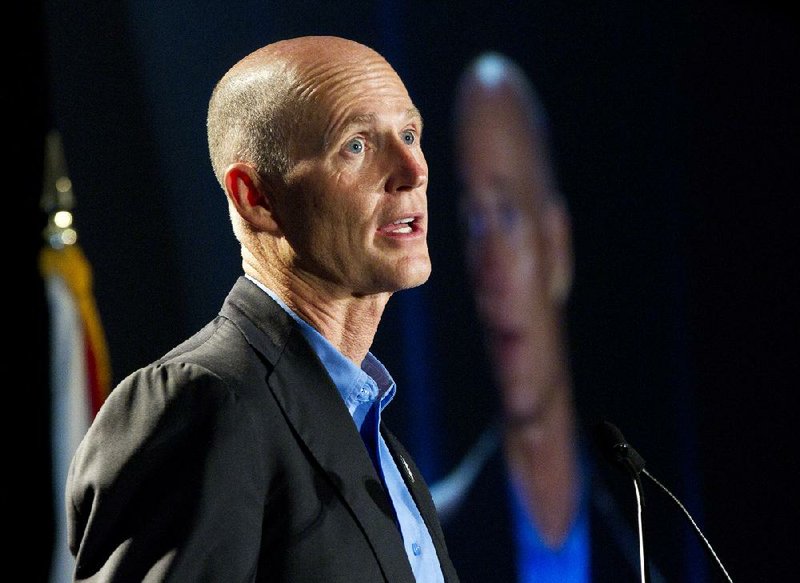 Florida Gov. Rick Scott (shown in this file photo) signed a $77 billion budget this summer that offers tax cuts while providing more money for education, museums, sewer projects and a bicycle trail. 