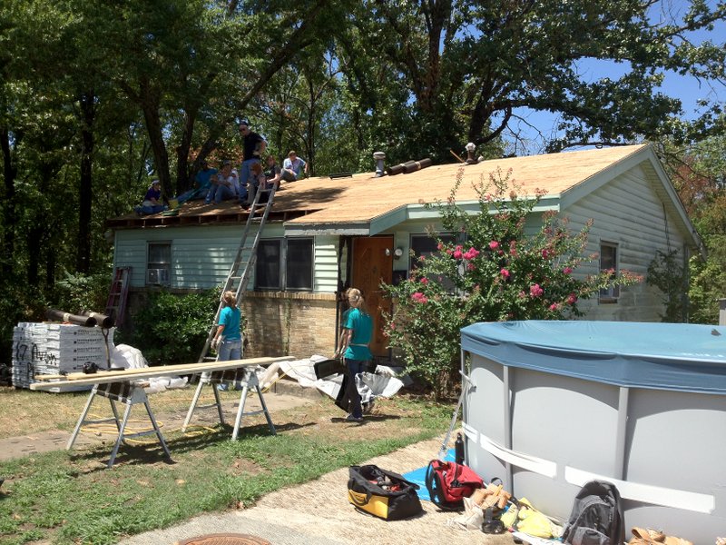 Several workers with the World Changers program renovate the home of Earl Brown in east Little Rock. Around 215 volunteers are working on houses around the city.