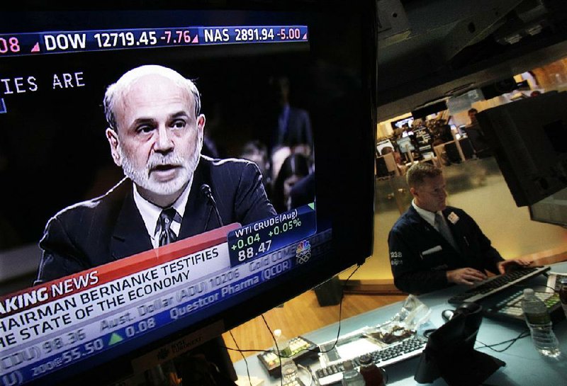 Federal Reserve Chairman Ben Bernanke’s testimony before a congressional committee is shown on television Tuesday on the floor of the New York Stock Exchange. 