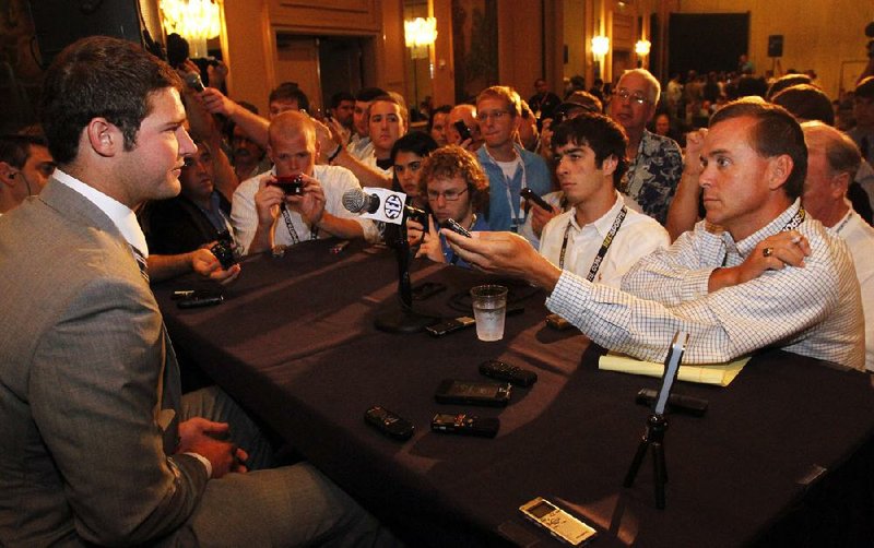 Arkansas quarterback Tyler Wilson speaks to the media at the Southeastern Conference NCAA college football media day in Hoover, Ala. on Wednesday, July 18 , 2012. (AP Photo/Butch Dill)