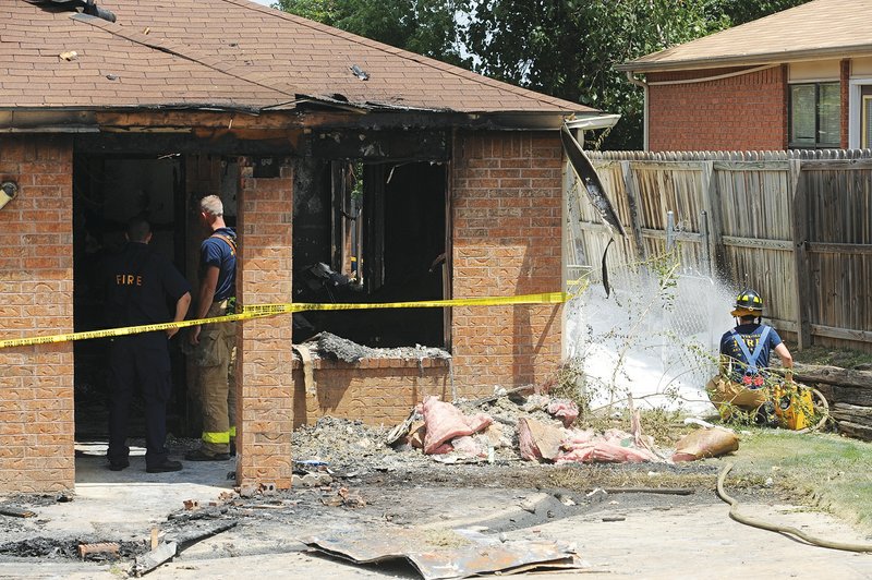 Firefighters work Thursday to extinguish a fire at a duplex at 678 W. Martha Drive in Fayetteville.