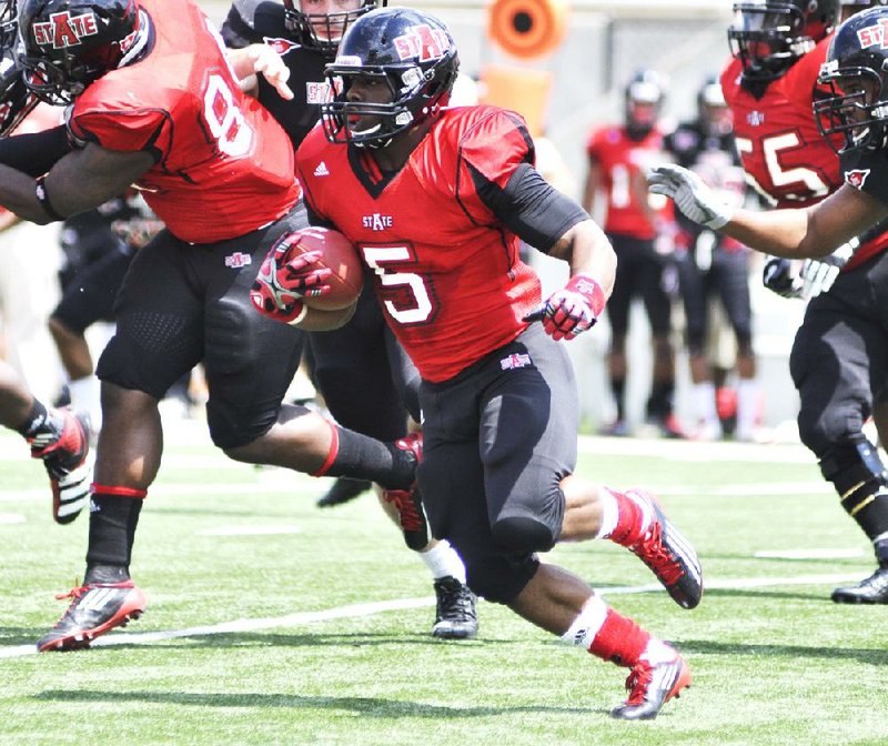 Courtesy Arkansas State/HANNAH DOLLE
Arkansas State running back Michael Dyer, who transferred from Auburn, looks for running room in the Red Wolves spring game at ASU Stadium in Jonesboro. ASU announced Sunday evening that Dyer has been dismissed from the team for violating team rules.
