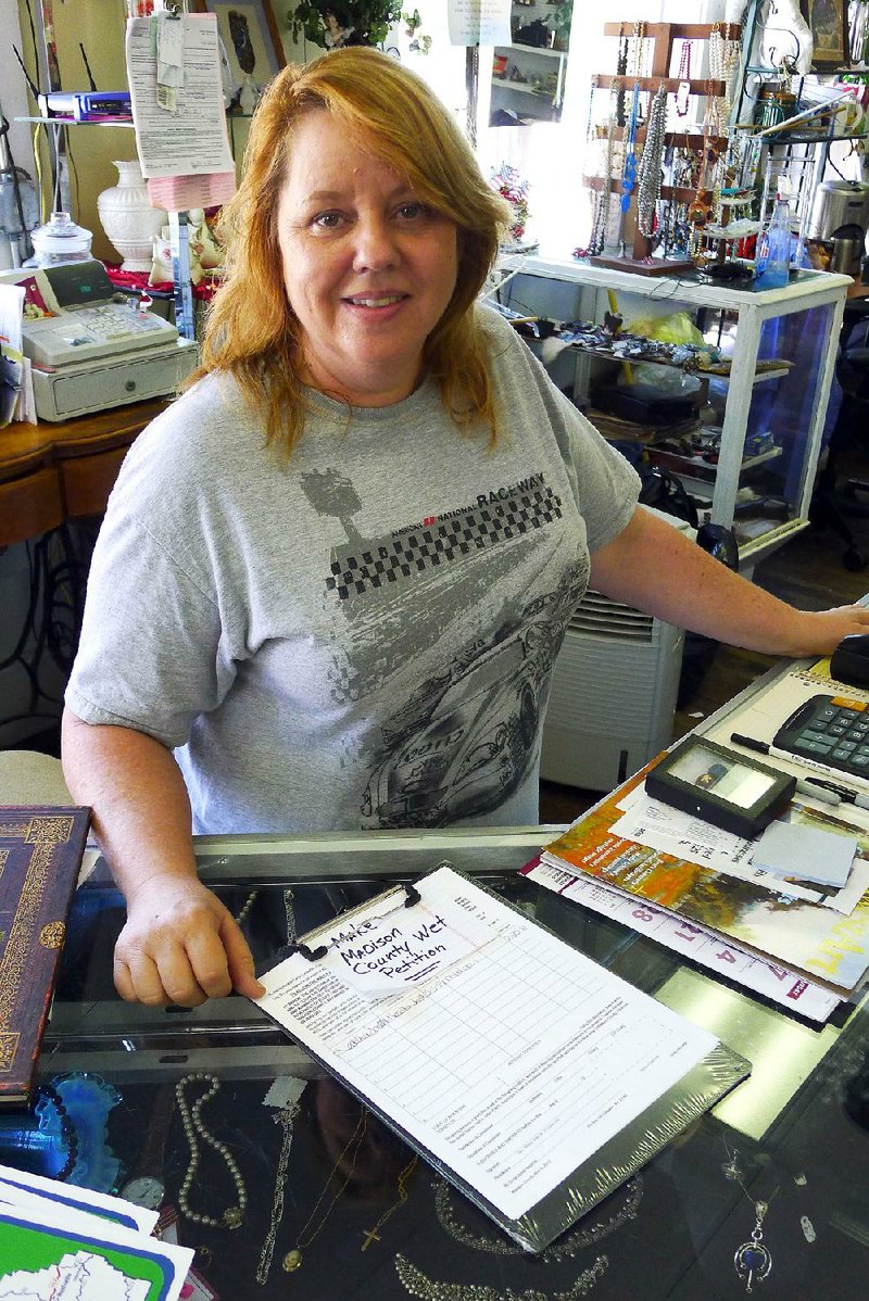 Arkansas Democrat-Gazette/BILL BOWDEN

7/20/12

Pamela Montoya, owner of Memory Lane Collectibles in Huntsville, has wet/dry petitions on the counter for people to sign.