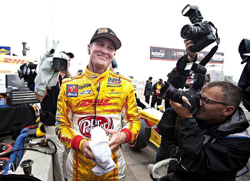 Ryan Hunter-Reay, from the United States, celebrates after winning the pole during qualifying for the IndyCar auto race in Edmonton, Alberta, on Saturday, July 21, 2012. But the IndyCar Series points leader will start 11th because he'll be penalized for an unapproved engine change. The penalty is 10 spots on the starting grid for Sunday's race. (AP Photo/The Canadian Press, Jason Franson)