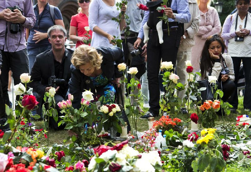 Norwegians lay flowers outside a cathedral Sunday in Olso on the first anniversary of a bombing and shooting rampage in Oslo and on Utoya Island. 