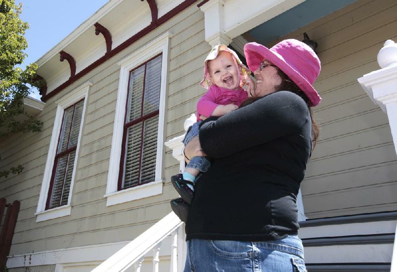 Sheila Dodson is seen with her daughter Emily outside their Victorian home Tuesday in Vallejo, Calif. 