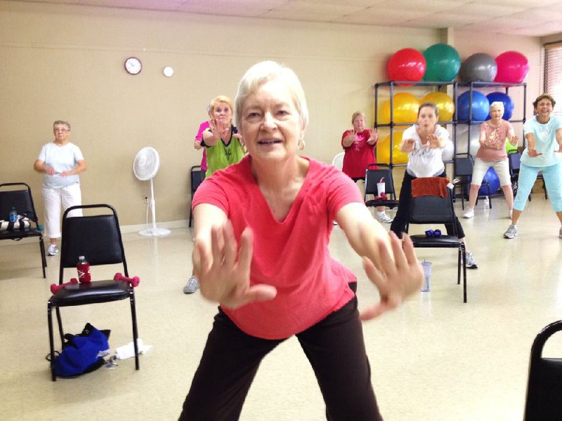 Pam Markham pushes herself in a good direction by dancing to contemporary pop tunes in a workout that’s designed for older women at Jazzercise in Conway. 