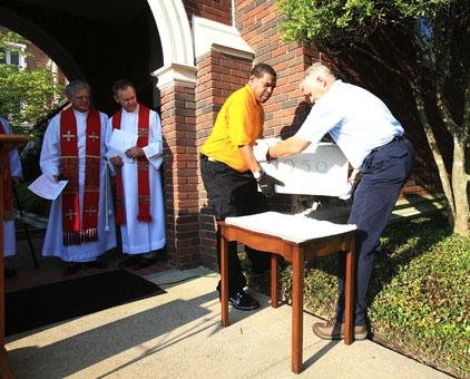 The Rev. Vic Nixon (left) and the Rev. Britt Skarda watch as Booker Rodgers and Larry Sweet (right) remove a cornerstone Sunday morning at Pulaski Heights United Methodist Church in Little Rock. The cornerstone was removed in order to open a time capsule placed behind the stone as part of the church’s centennial celebration. Video is available at arkansasonline.com/videos. 