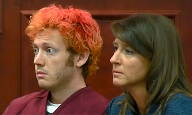 In this image taken from video provided by KUSA.com, James Holmes, left, the suspected gunman the Aurora, Colo., theater massacre, makes his first appearance in court with his attorney Tamara Brady in Centennial, Colo. on Monday, July 23, 2012.