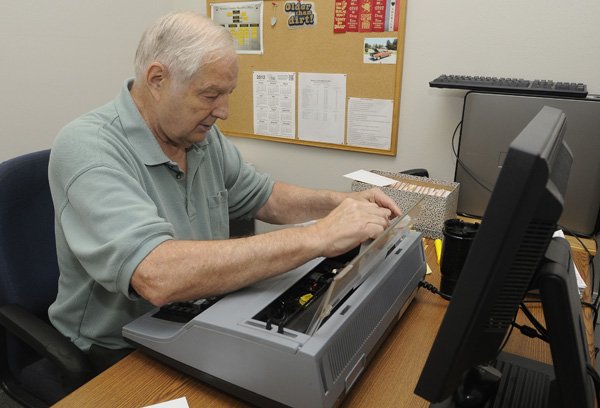 Harold Krantz, president of the Bella Vista Crime Watch, types up cards with information about stolen property while volunteering at the Benton County Sheriff’s Office in Bentonville. Krantz has been volunteering with the crime watch program for 20 years and with the Sheriff’s Office for more than 10 years.