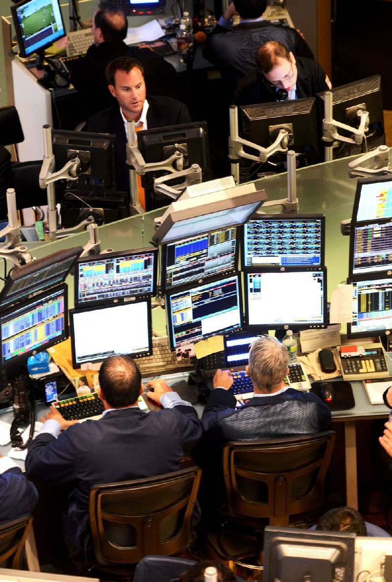 Traders work Monday at the New York Stock Exchange, where Spain bailout fears sent stocks tumbling. 