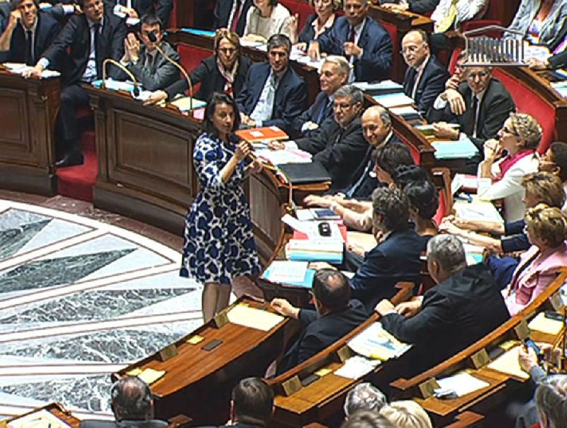 Housing Minister Cecile Duflot speaks before France’s National Assembly in Paris last week in this image from TV. The hooting and catcalls began as soon as the Cabinet minister stood, wearing a blue and white flowered dress. 