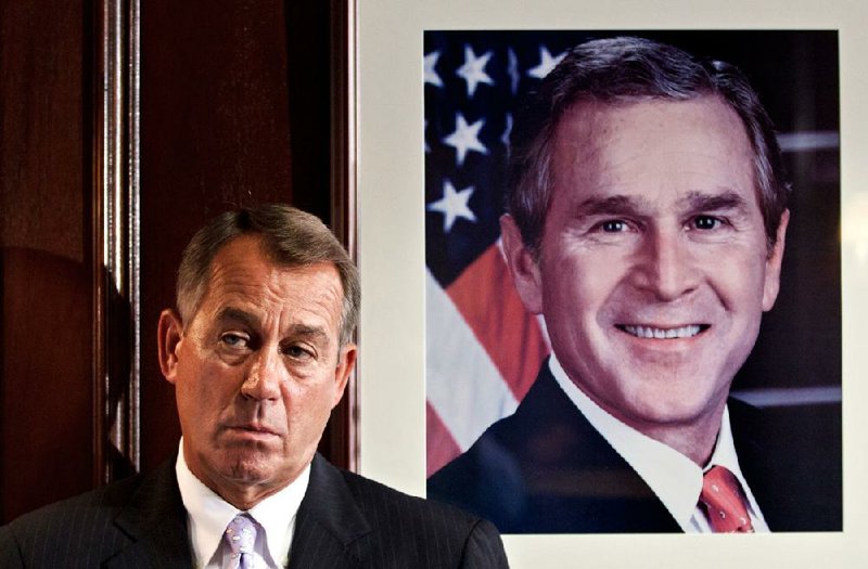 House Speaker John Boehner waits to address reporters Tuesday at the Capitol near a portrait of former President George W. Bush. A letter Tuesday to Boehner from the Congressional Budget Office director warned that repeal of the health-care law would increase budget deficits. 