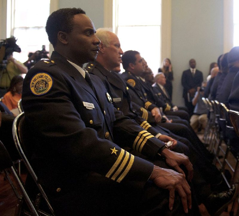 New Orleans police commanders listen Tuesday in New Orleans’ historic Gallier Hall as Attorney General Eric Holder announces a federal consent decree on changes in their Police Department. 
