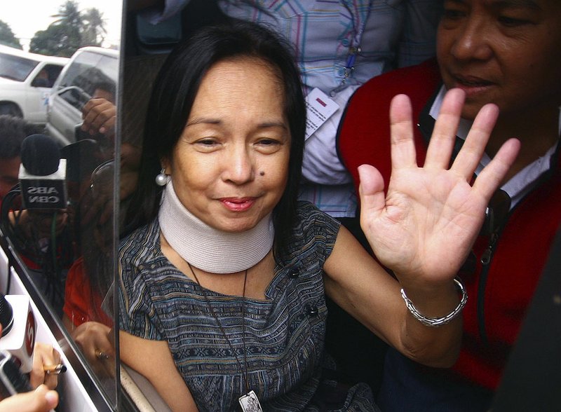 Former Philippine President Gloria Macapagal Arroyo she arrives at her village in suburban Quezon City, north of Manila, Philippines, on July 25, 2012, after leaving a government hospital where she had been detained for nearly eight months on charges of election sabotage.