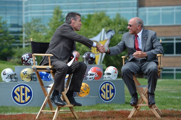 Arkansas football coach John L. Smith (right) greets ESPN personality Chris Fowler on Tuesday in Bristol, Conn. 