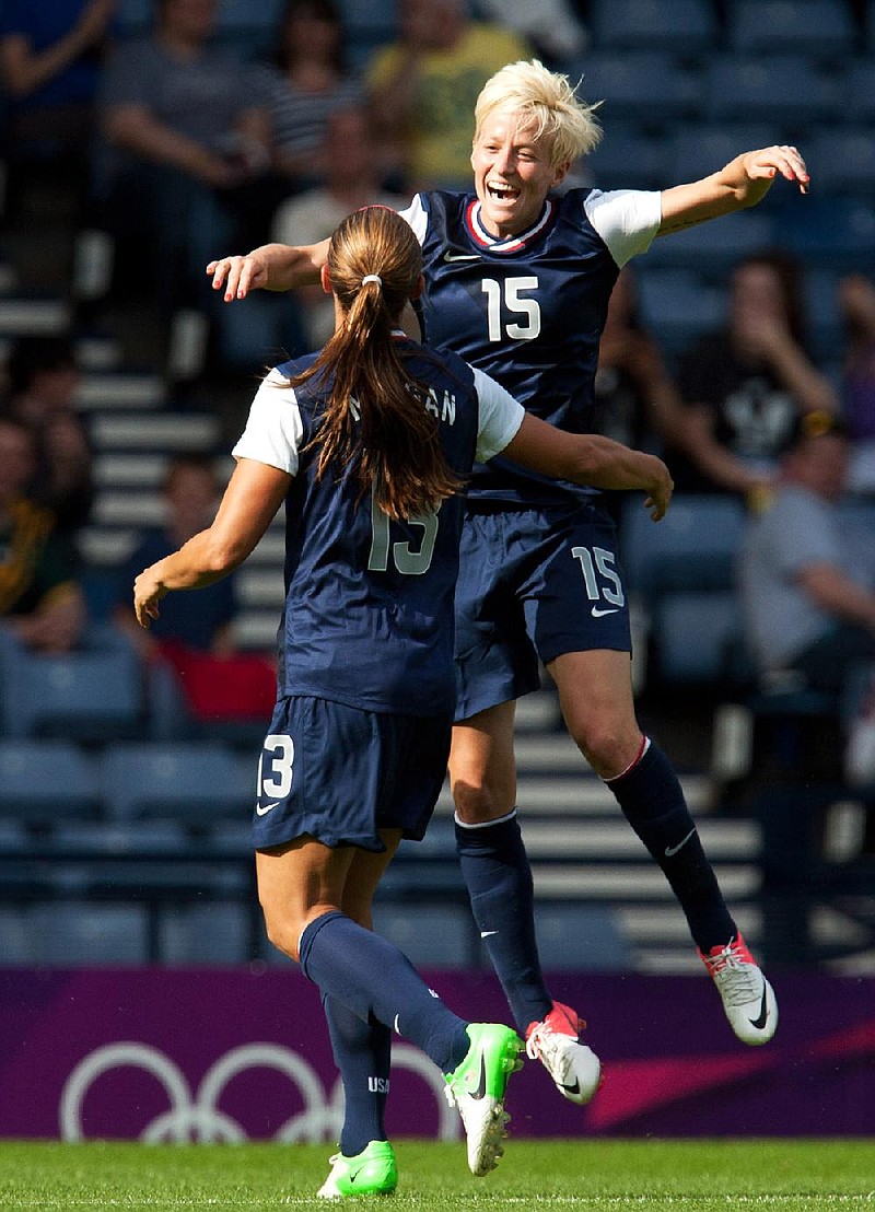 Megan Rapinoe (15) and Alex Morgan celebrate after Morgan scored one of her two goals in a 4-2 victory over France in the United States’ Olympic opener at Hampden Park in Glasgow, Scotland, on Wednesday. 