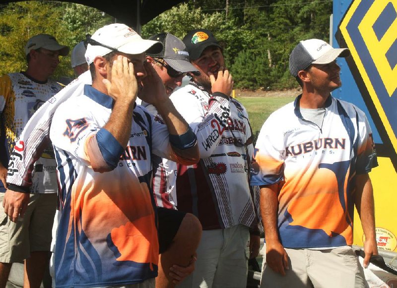 Auburn brothers Matt (left) and Jordan Lee (right) spend a little time with Alabama anglers Duyston Connell (second from left) and Logan Johnson as they wait for weigh-ins to start Thursday in the Bassmaster College Series National Championships. Both schools reached today’s final round. Video is available at arkansasonline.com/videos. 