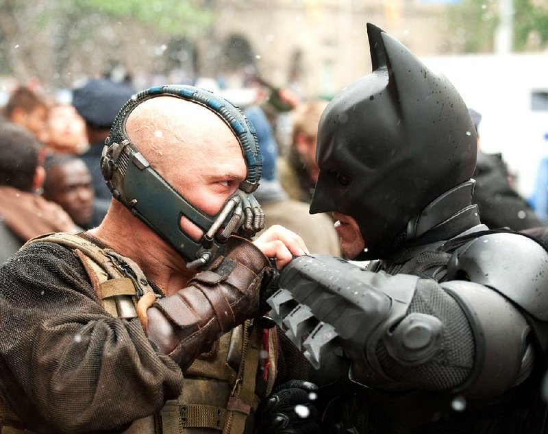 Tom Hardy (left) plays Bane and Christian Bale stars as Batman in the action thriller The Dark Knight Rises. The film made more than $160 million at last weekend’s box office. 