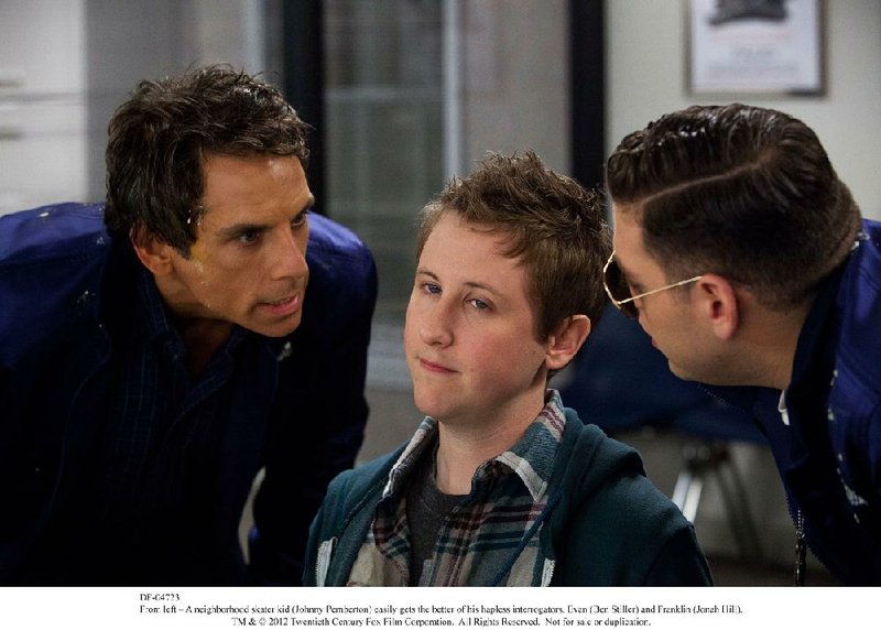 Evan (Ben Stiller) and Franklin (Jonah Hill) attempt to interrogate a neighborhood skateboard kid (Johnny Pemberton) in Akiva Schaffer’s The Watch. 