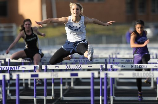 Har-Ber sophomore Payton Stumbaugh, center, leads the field Friday, March 9, 2012, during the 100-meter hurdles in the annual Bulldog Relays at Harmon Field in Fayetteville.
