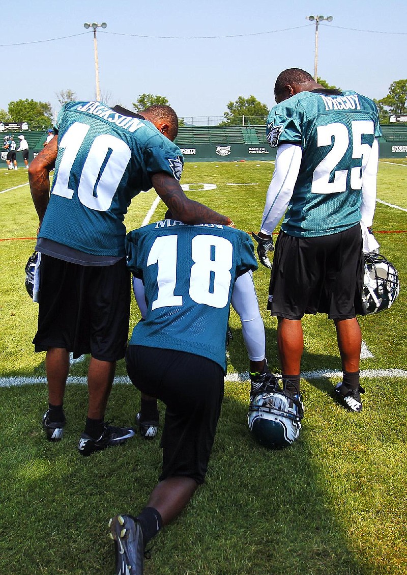 Philadelphia Eagles teammates DeSean Jackson (10), Jeremy Maclin (18) and LeSean McCoy (25) take a break on the sidelines at the Eagles’ training camp at Lehigh University in Bethlehem, Pa. The Eagles are enjoying a camp without distractions or drama. 