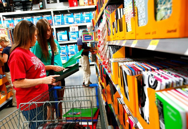 Loyce Smith (left) shops with her daughter, Hailey Smith, 19, a student at Arkansas Tech University, in the back-to-school section of the Wal-Mart Supercenter on Mall Avenue in Fayetteville on Thursday. 