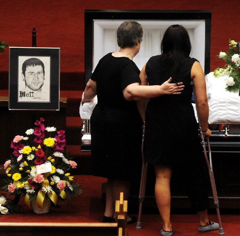 Samantha Yowler (right) pays her final respects to boyfriend Matt McQuinn at his funeral Saturday in Springfield, Ohio. 