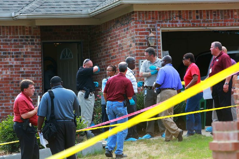 Little Rock police gather at the home of Bobby and Annette Whitlow, who were found dead Saturday afternoon. 
