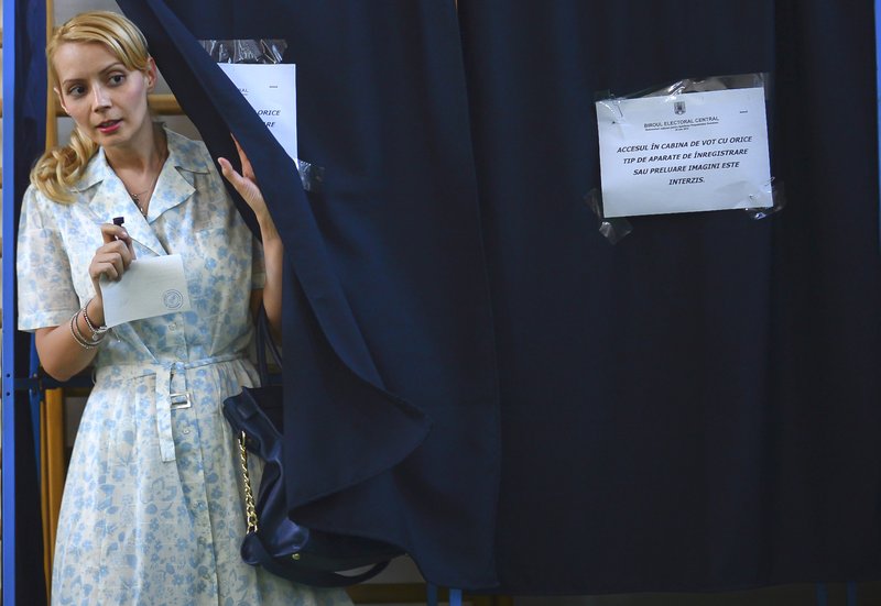 Daciana Sarbu, wife of Romanian Premier Victor Ponta, not seen, exits a voting cabin during a referendum on the Romania's president impeachment in Bucharest, Romania, Sunday, July, 29, 2012. Romania is holding a referendum on impeaching President Traian Basescu, part of a political battle that has raised questions about the rule of law in the fledgling EU member. 
