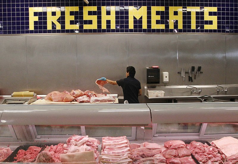 Butcher Freddie Quina cuts meat Wednesday at a supermarket in Oklahoma City. Nationally, beef prices are expected to rise by up to 5 percent next year. Poultry and egg prices are projected to rise 3 to 4 percent, and pork prices 2.5 to 3.5 percent. 