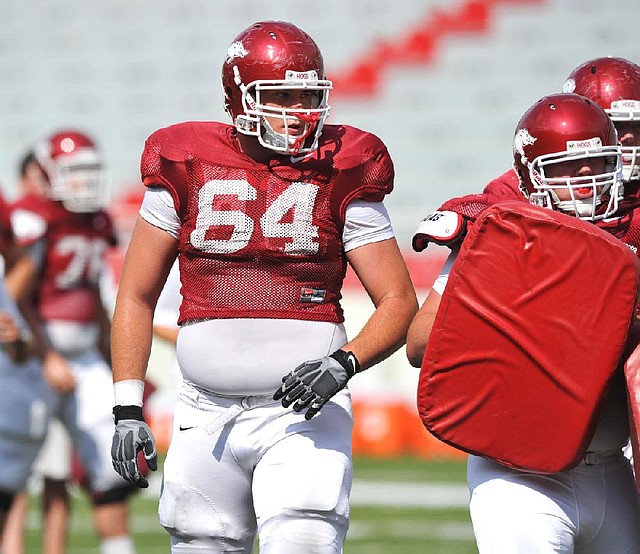 Junior center Travis Swanson is set to be the starting center for the Arkansas Razorbacks this season, but coaches Paul Petrino and Chris Klenakis said the other offensive line positions must be won through competition. 