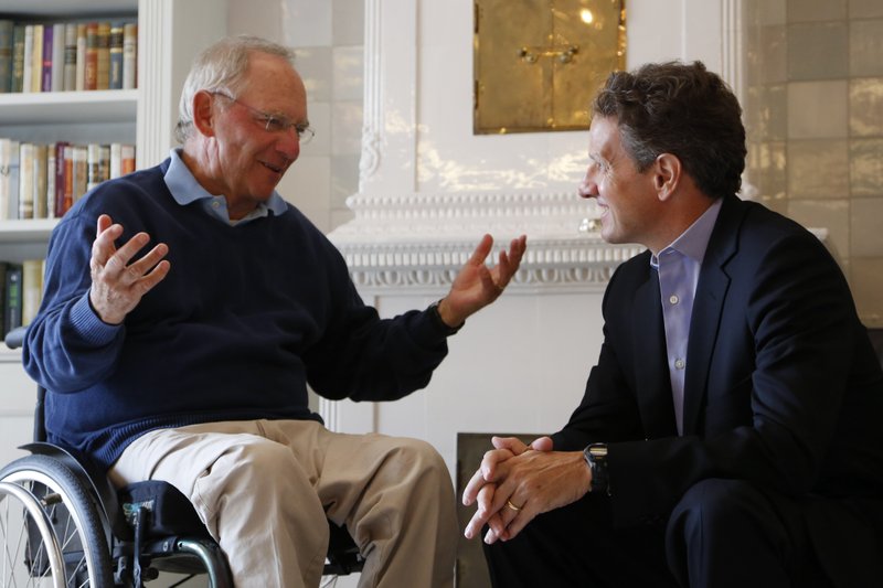 German Finance Minister Wolfgang Schaeuble, left, speaks with U.S. Treasury Secretary Timothy Geithner, right, in the house where Schaeuble is vacationing, in Westerland on the North Sea island of Sylt, Germany Monday July 30, 2012.