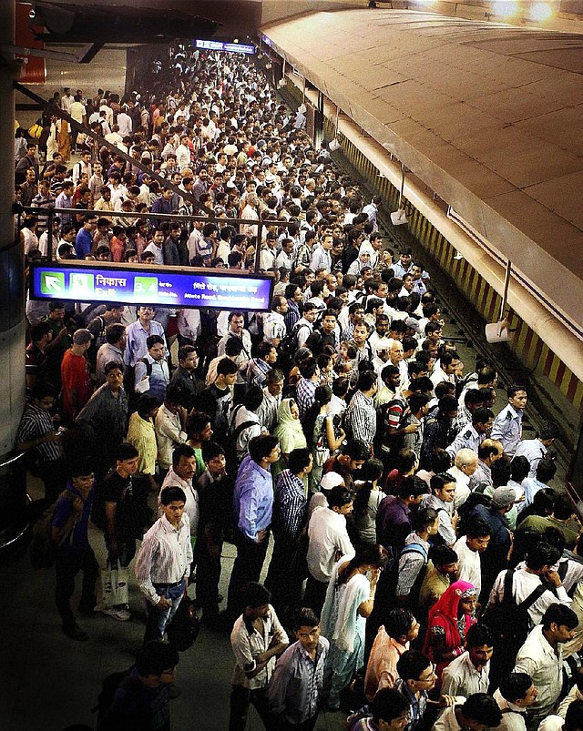 Commuters wait for a metro train Monday in New Delhi. Northern India’s power grid crashed Monday, halting hundreds of trains, forcing hospitals and airports to use backup generators and leaving 370 million people sweltering in the summer heat. 