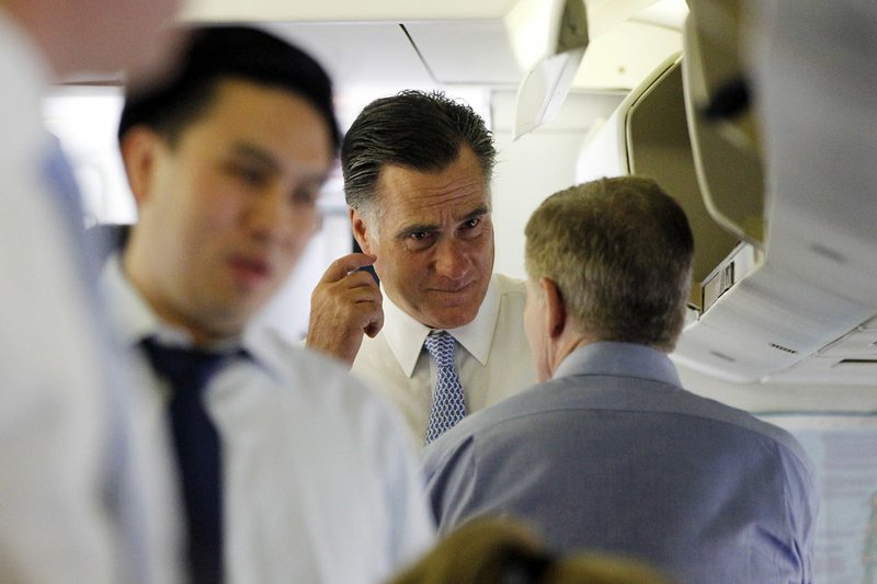 Republican presidential candidate and former Massachusetts Gov. Mitt Romney talks to strategist Stuart Stevens, right, on  Monday, July 30, 2012, as adviser Lanhee Chen stands left as they board their charter plane in Tel Aviv, Israel, on the way to Poland.
